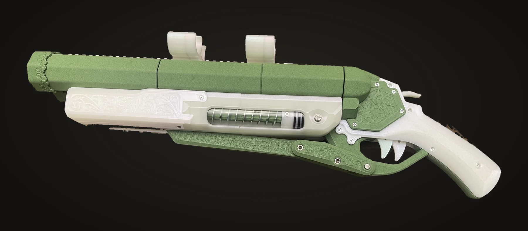 Green and white kit blaster I printed and built, with filigree detailing and a toothed trigger guard
