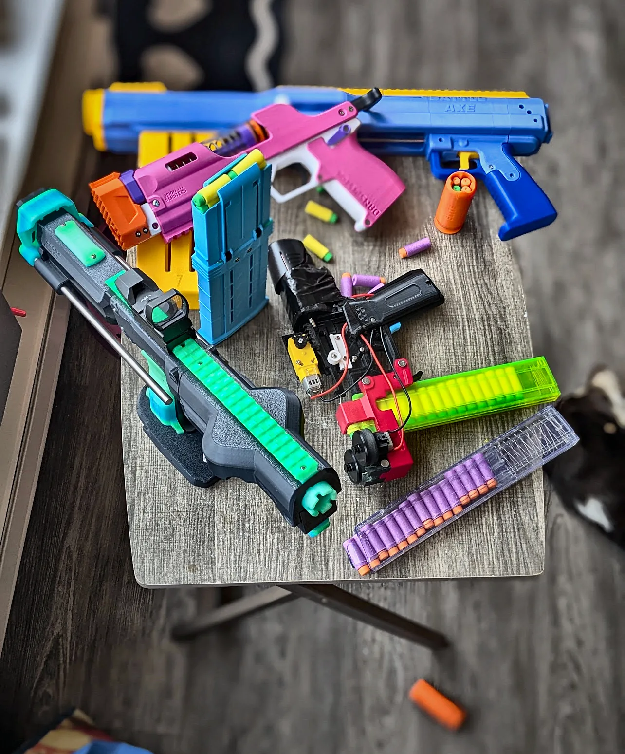A table of printed blasters, magazines and darts