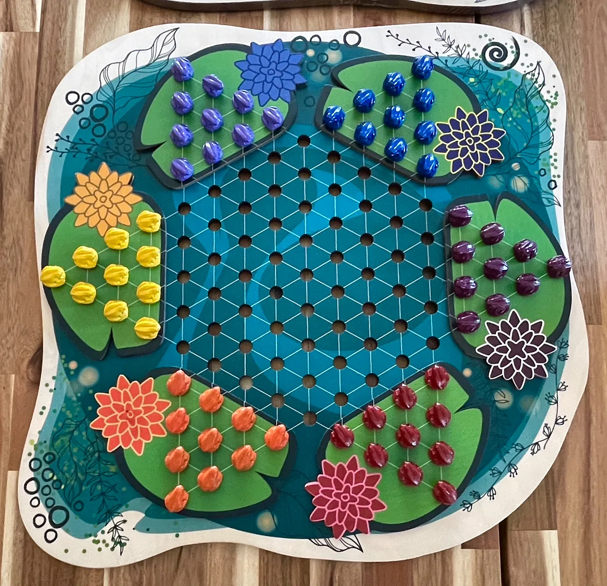 Lily pad Chinese checkers board with my frog pieces in six colors