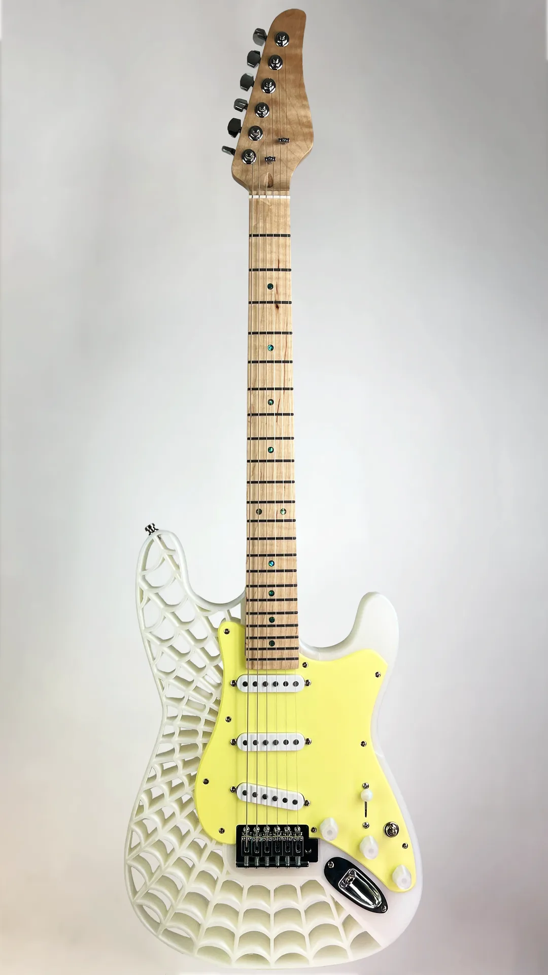 White 3D-printed guitar with a web-pattern body and yellow pickguard